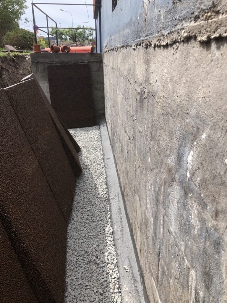 Rengjord husgrund efter schaktning inför montering av dräneringsskiva.